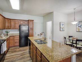 South Jordan townhouse for rent - Kitchen with Brown Cabinets at San Tropez