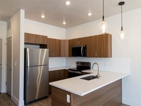 Washington townhouse for rent - Kitchen with Brown Cabinets at The Ash Apartments & Townhomes