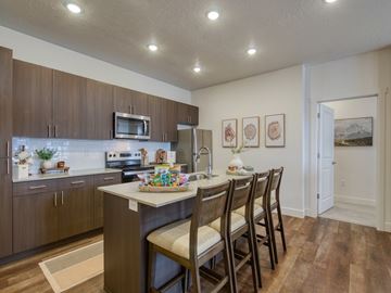 Idaho Falls apartment for rent - A kitchen with brown cabinets and a white island.