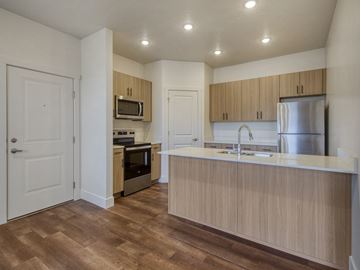 Idaho Falls apartment for rent - A kitchen with wooden cabinets and a white countertop.