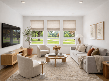 Billings apartment for rent - A living room with a grey couch, a wooden coffee table, and a large window with blinds.