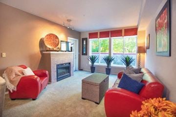 Renton apartment for rent - a living room with a red couch and a fireplace