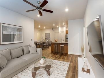 Logan apartment for rent - a living room with a couch and a ceiling fan