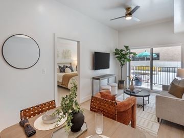 Salt Lake City apartment for rent - A living room with a brown chair and a white table.