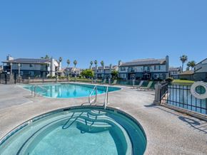 Fresno townhouse for rent - A swimming pool with a slide in the middle of it.