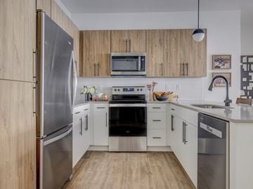 Provo townhouse for rent - A modern kitchen with wooden cabinets and stainless steel appliances.
