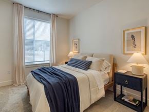 Idaho Falls townhouse for rent - A bedroom with a bed, nightstand, and window.
