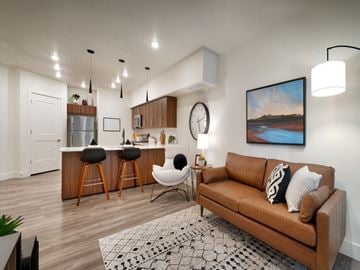 Salt Lake City apartment for rent - A living room with a brown couch and a painting on the wall.