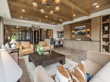 Provo townhouse for rent - A living room with a wooden ceiling and a coffee table in the center.