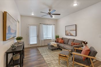 Open living area with ceiling fan
