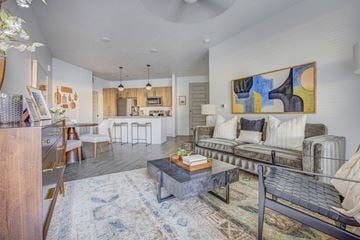 Lehi apartment for rent - A living room with a couch, a coffee table, and a painting on the wall.
