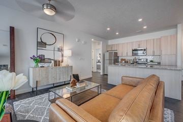 Draper apartment for rent - A living room with a brown leather couch and a coffee table.
