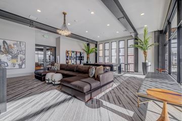 Draper apartment for rent - A modern living room with a large brown couch and a wooden coffee table.