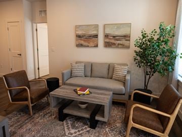 Cheyenne townhouse for rent - A living room with a grey couch, two chairs and a coffee table.