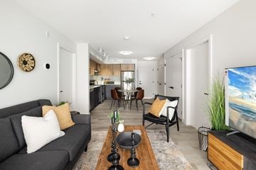 Penticton apartment for rent - A living room with a grey couch and a wooden coffee table.