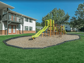 Newnan apartment for rent - A playground with a green slide and a sandbox.