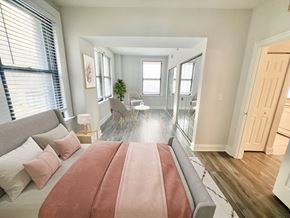 Philadelphia apartment for rent - a bedroom with a bed and a living room with a dining room