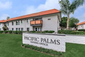 Palm Springs apartment for rent - A building with a sign that says Pacific Palms Leasing Office.