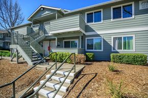 Bay Point apartment for rent - A grey two story apartment building with a staircase leading to the second floor.