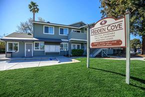Bay Point apartment for rent - A sign for Hidden Cove Apartments stands in front of a two-story building.