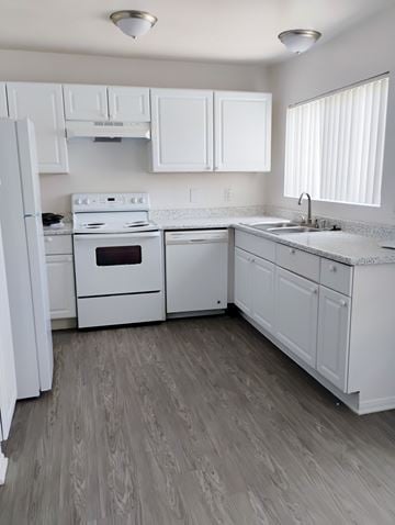 Winnetka townhouse for rent - A white kitchen with a stove, oven, and sink.