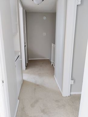 Winnetka townhouse for rent - A white hallway with a carpeted floor and a white door on the left.