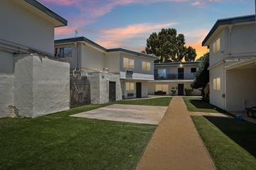 Winnetka apartment for rent - A pathway leads through a grassy area between two rows of houses.