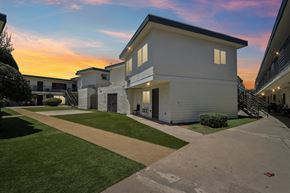 Winnetka apartment for rent - A row of white houses with a sunset in the background.