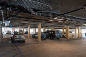 Inglewood apartment for rent - A parking garage with cars parked in it.