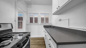 Long Beach apartment for rent - a kitchen with a stove and a sink and a window