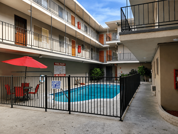 Van Nuys apartment for rent - A pool surrounded by a black fence with a sign that says "NO POWER" on it.