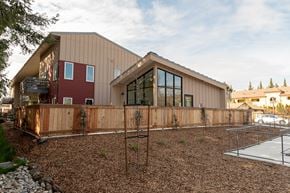 Healdsburg apartment for rent - A modern house with a red section and a wooden fence.