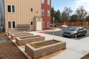 Healdsburg apartment for rent - A car is parked in a parking lot next to a building.