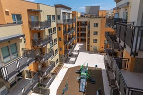 Richmond apartment for rent - Apartment complex with a playground in the courtyard.