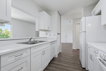 Placerville apartment for rent - A white kitchen with a sink and a refrigerator.