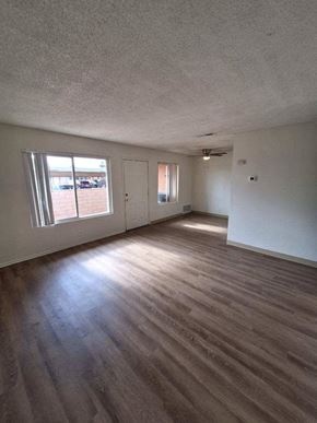 Coachella apartment for rent - an empty living room with a hard wood floor