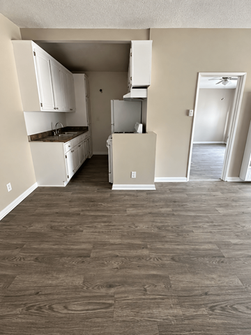 Reseda apartment for rent - A kitchen with white cabinets and a refrigerator.