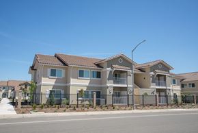 Live Oak apartment for rent - A row of houses with a clear blue sky above them.