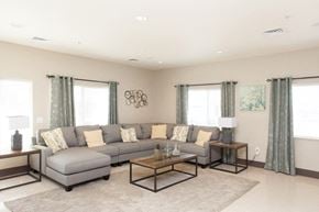 Douglas apartment for rent - a living room with a gray couch and a coffee table