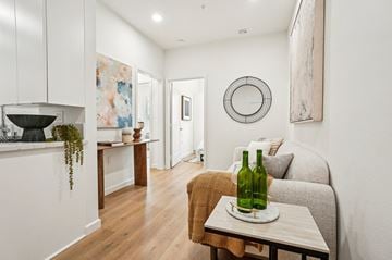 Los Angeles apartment for rent - A living room with a grey couch and a green bottle on a table.