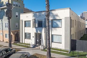 Long Beach apartment for rent - A white building with a black gate in front.