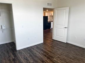 Elk Grove apartment for rent - A room with a black fridge and a white door.
