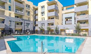 Gilroy apartment for rent - a swimming pool in front of an apartment building
