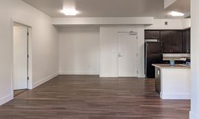 Gilroy apartment for rent - an empty kitchen and living room with wood floors and white walls