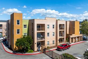 Oakland apartment for rent - A red car is parked in front of a building.