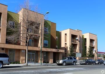 Oakland apartment for rent - A row of apartment buildings with cars parked in front.