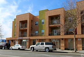 Oakland apartment for rent - A multi-story apartment building with cars parked in front.