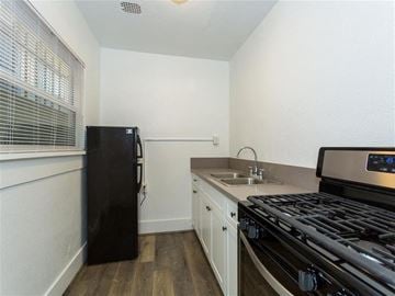 Long Beach apartment for rent - a kitchen with a stove and a sink and a refrigerator