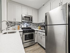 San Pedro apartment for rent - a kitchen with stainless steel appliances and white cabinets at Harbor Terrace Apartments, San Pedro