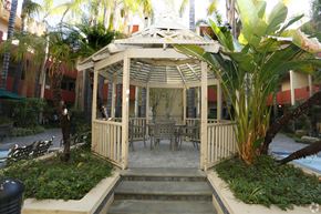 Los Angeles apartment for rent - A gazebo with a table and chairs is surrounded by plants.